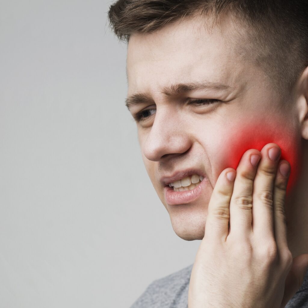 How Does Oral Health Affect Overall Health 1 I mean in discomfort holding his cheek that looks very red to indicate pain to help illustrate Emergency Dentist Needed