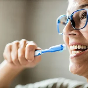 Lady brushing her teeth
