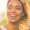 Smiling woman in a field to help illustrate five types of cosmetic dentistry procedures