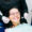 Smiling woman in dentist chair as a dentist holds a dental mirror and scaler nearby to help illustrate restorative dental procedures.