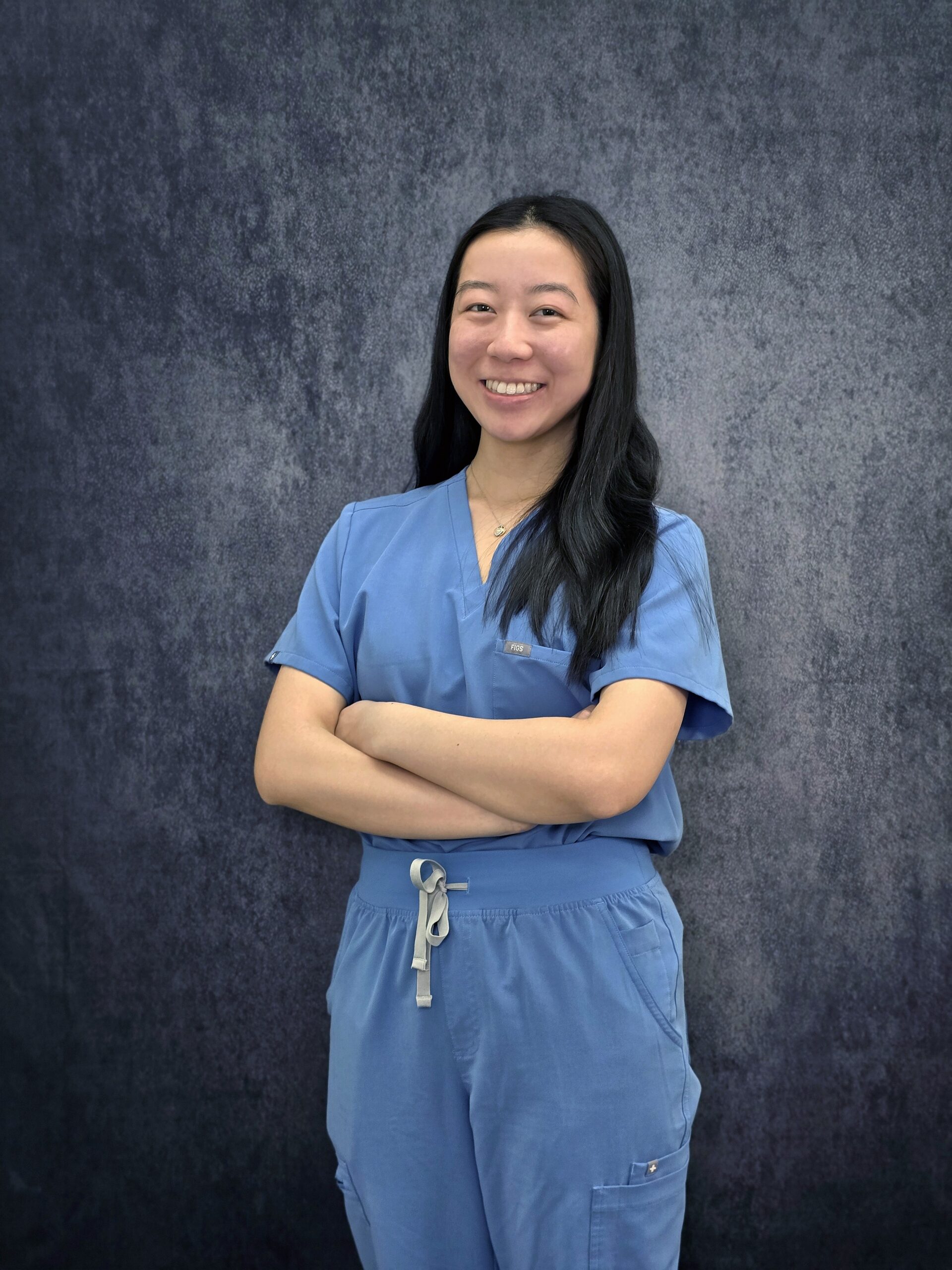 Jennifer Asian Dental Assistant in Blue Scrub Smiling