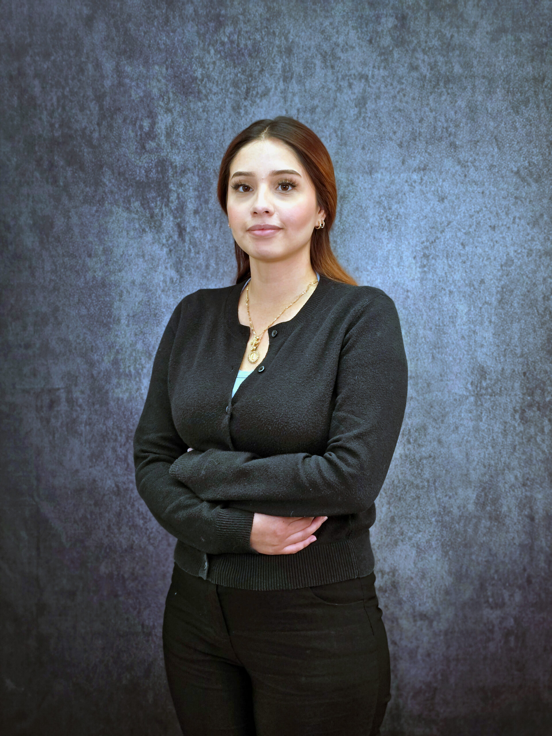 Magdalena Hispanic Girl in black clothes smiling with arms crossed