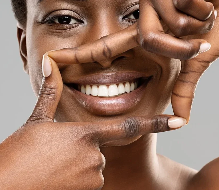 Cosmetic Dentist 6 A woman’s smile framed by her hands.