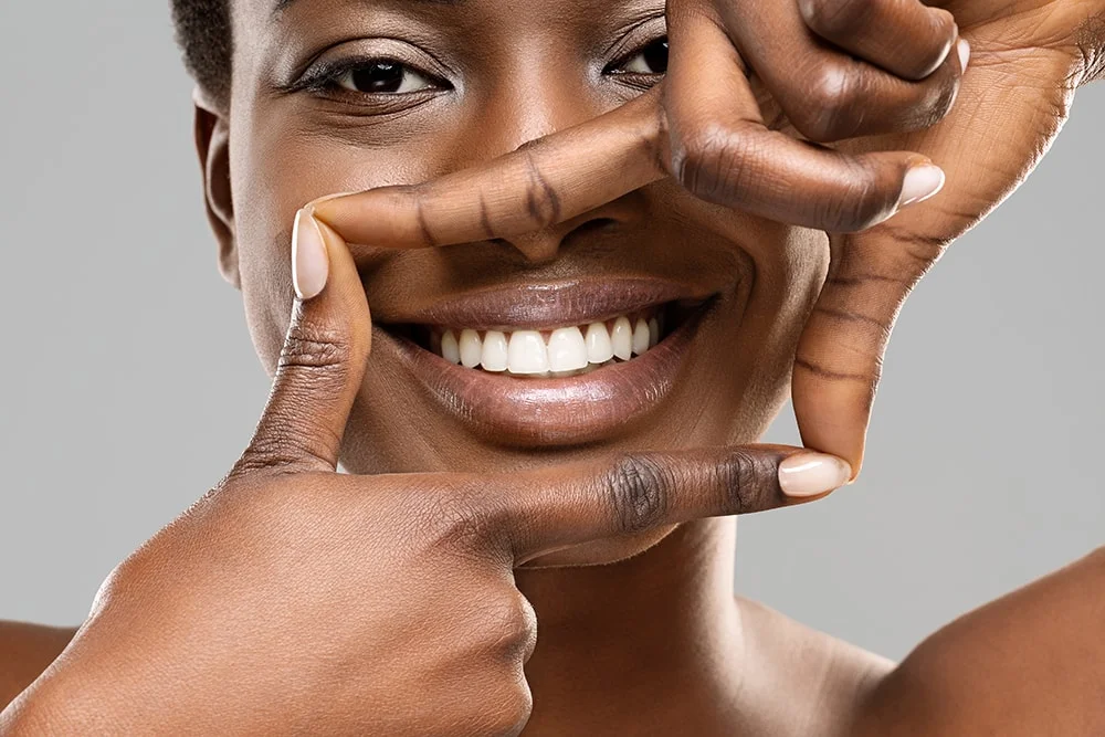 Cosmetic Dentist 6 A woman’s smile framed by her hands.