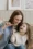 a mother and daughter holding wooden toothbrushes