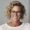 a woman with glasses smiling