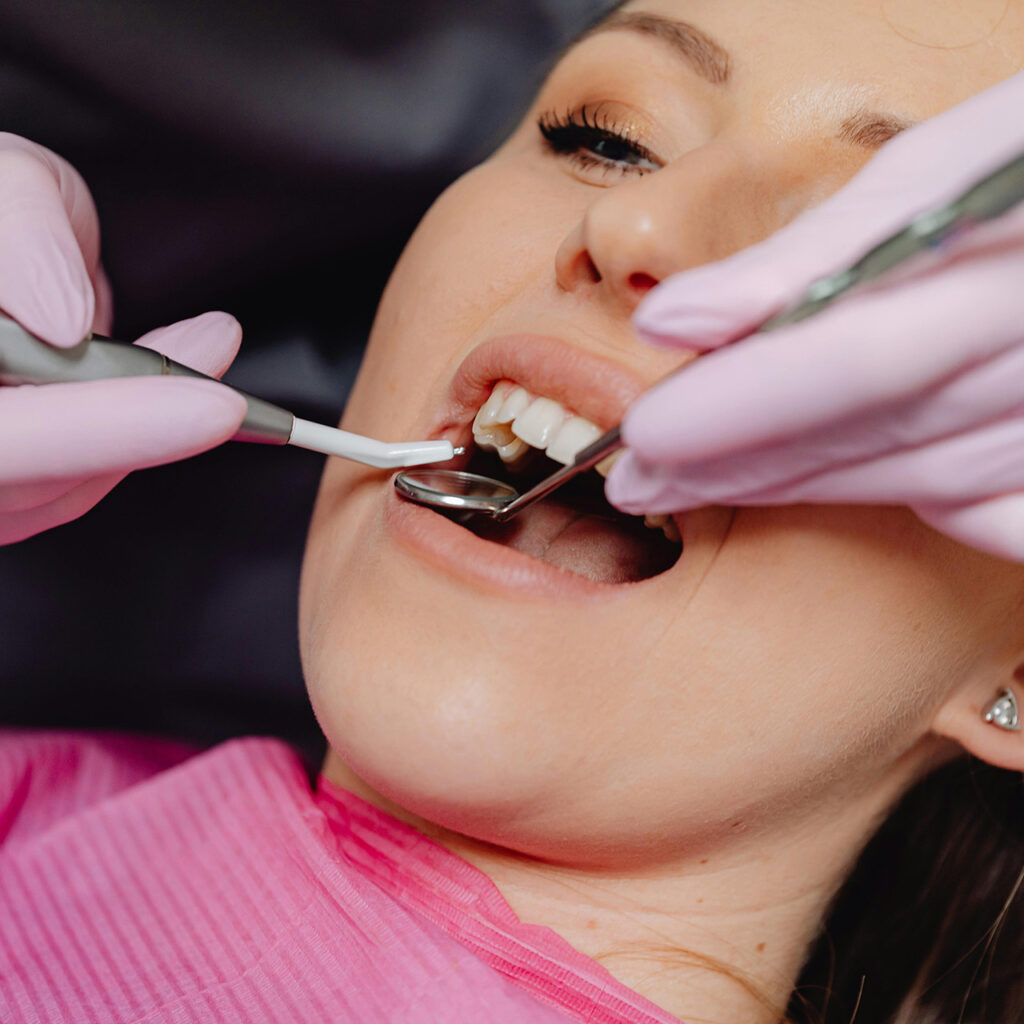 Dental Implants 3 A dentist using tools during a patient’s appointment for dental implant services in Whittier