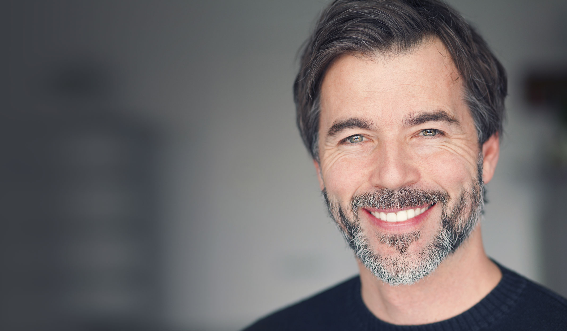 A man smiling after receiving dental implants in Whittier, CA