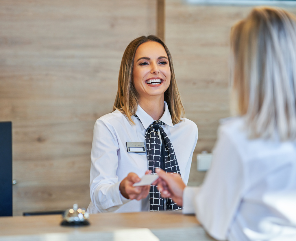 A happy person giving a piece of paper to someone else