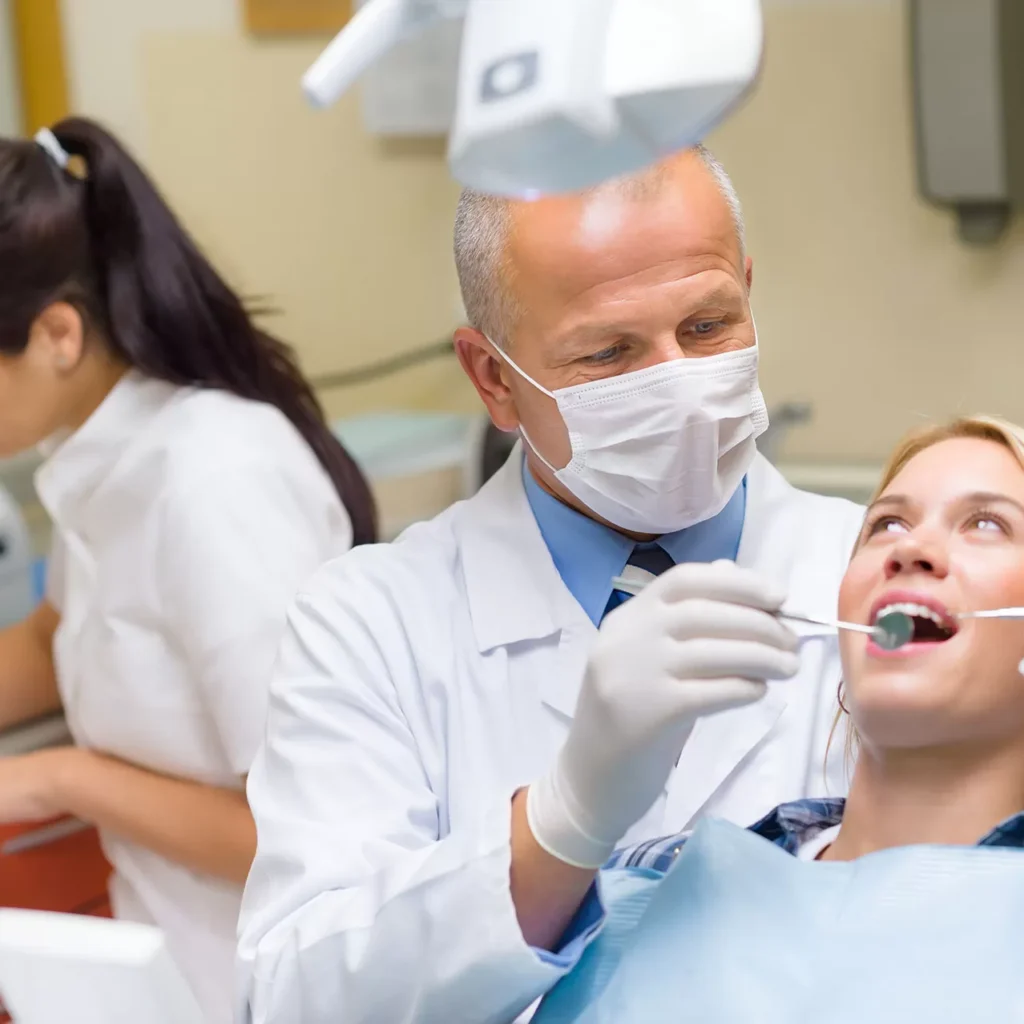a dentist examining a female patient’s teeth