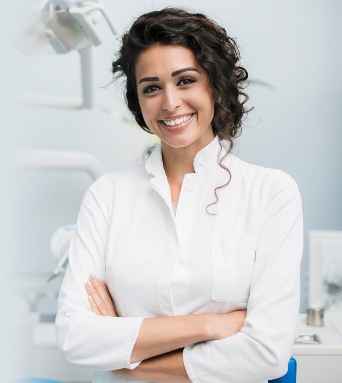 a smiling female dentist in her office