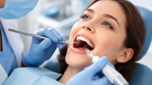 A patient receiving a gentle professional teeth cleaning and hygiene treatment at Perfect Smile Dental Group in South Whittier.